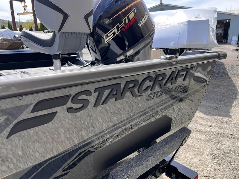Slide: The Image of 2025 Starcraft Storm 176 DC Pro SE boat with Yamaha engine, parked outdoors. - 25