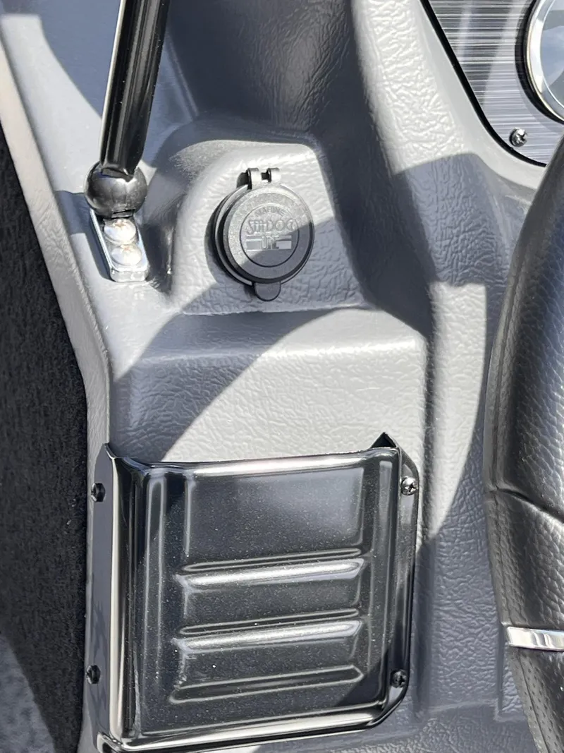 Slide: The Image of 2025 Starcraft Storm 176 DC Pro SE dashboard detail with power socket and textured surface. - 26