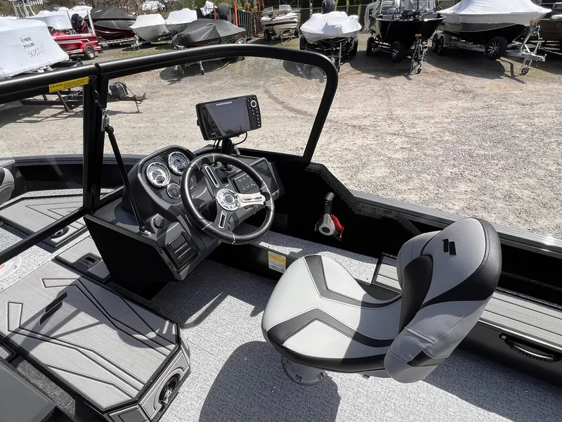 Slide: The Image of 2025 Starcraft Storm 176 DC Pro SE boat interior with steering wheel and navigation system. - 36