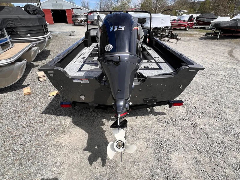 Slide: The Image of 2025 Starcraft Storm 176 DC Pro SE boat with powerful outboard motor, parked on gravel. - 5