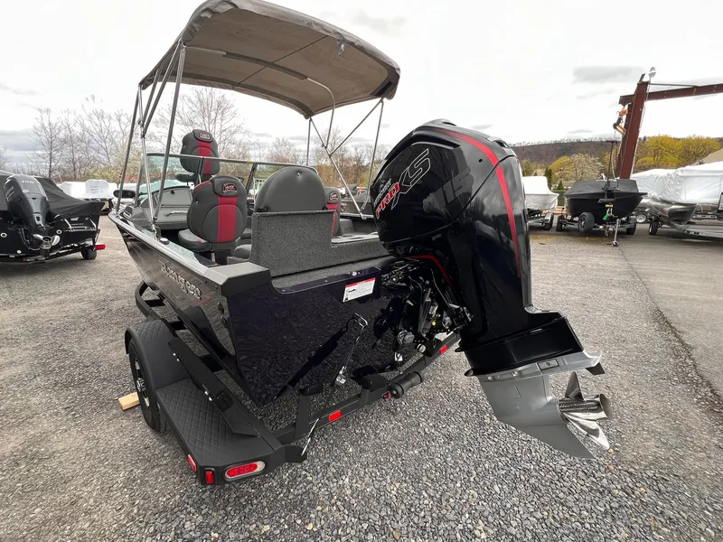 Slide: The Image of 2020 Ranger VS1782 WT boat with canopy and powerful outboard motor in a parking lot. - 11