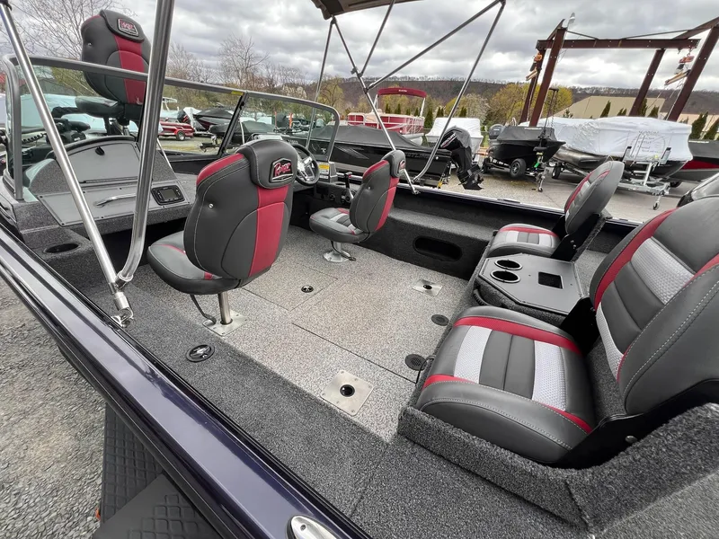 Slide: The Image of 2020 Ranger VS1782 WT boat interior with red and gray seating, cup holders, and windshield. - 12