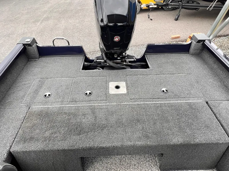 Slide: The Image of 2020 Ranger VS1782 WT boat deck with motor, featuring carpeted surface and storage compartments. - 19