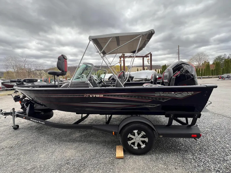 Slide: The Image of 2020 Ranger VS1782 WT boat with canopy on trailer, under cloudy sky. - 24