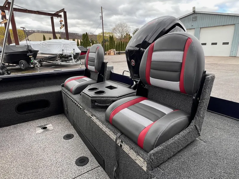 Slide: The Image of 2020 Ranger VS1782 WT boat interior with dual seats and motor, parked outdoors. - 26
