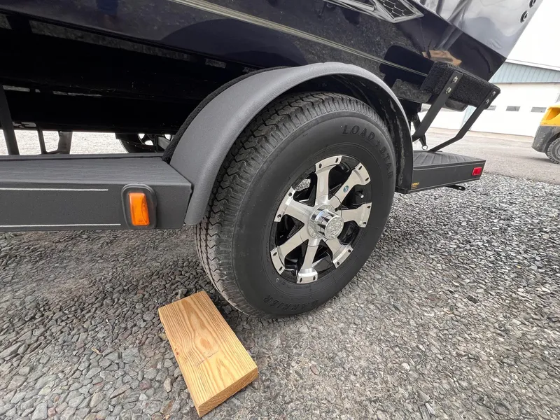 Slide: The Image of 2020 Ranger VS1782 WT trailer wheel on gravel with wooden block support. - 29