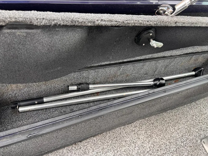 Slide: The Image of 2020 Ranger VS1782 WT boat storage compartment with metal poles inside. - 32