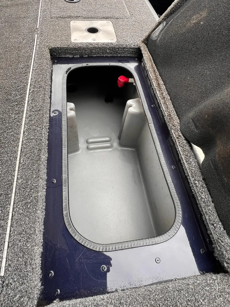 Slide: The Image of 2020 Ranger VS1782 WT boat storage compartment with open lid, showing interior details. - 35