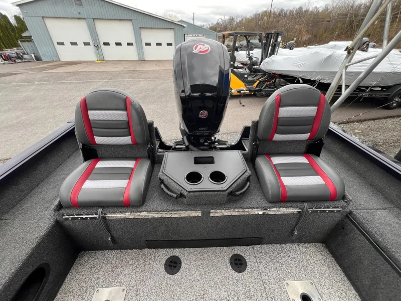 Slide: The Image of 2020 Ranger VS1782 WT boat interior with dual seats and motor, parked outdoors. - 44