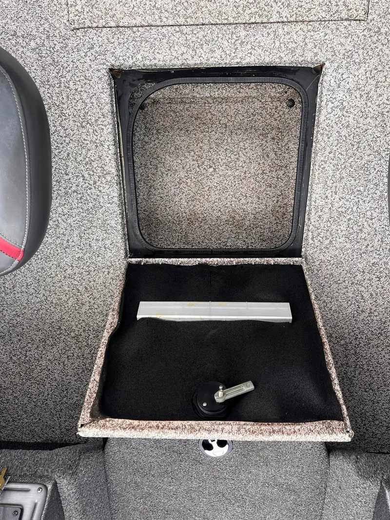 Slide: The Image of 2020 Ranger VS1782 WT boat storage compartment with open lid and handle. - 8