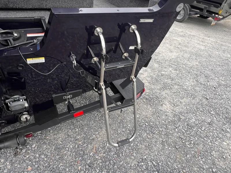 Slide: The Image of 2020 Ranger VS1782 WT boat with a stainless steel boarding ladder on gravel surface. - 9