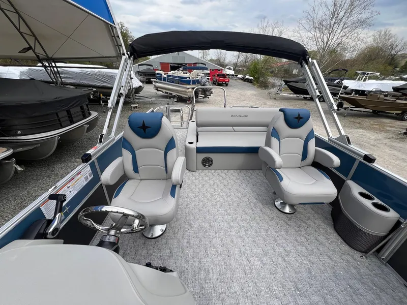Slide: The Image of 2025 Berkshire LE Series 24UL LE pontoon boat interior with plush seating and steering console. - 13