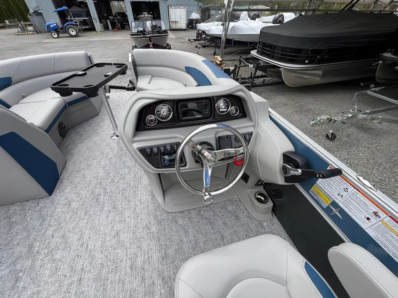 Slide: The Image of 2025 Berkshire LE Series 24UL LE pontoon boat interior with steering console and seating. - 14
