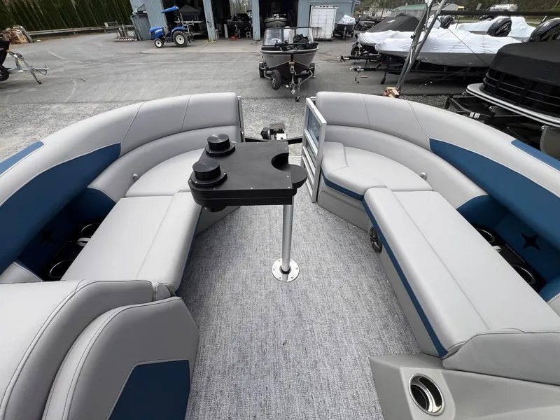 Slide: The Image of 2025 Berkshire LE Series 24UL LE pontoon boat interior with gray and blue seating. - 2