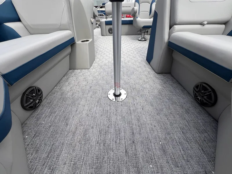 Slide: The Image of 2025 Berkshire LE Series 24UL LE boat interior with gray carpet and blue-gray seating. - 29