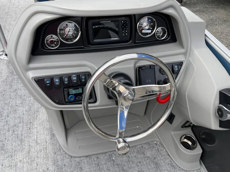 Slide: The Image of Steering console of 2025 Berkshire LE Series 24UL LE boat with gauges and controls. - 3