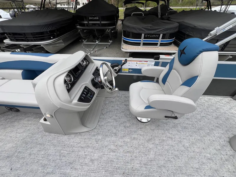 Slide: The Image of 2025 Berkshire LE Series 24UL LE boat interior with captain's chair and control panel. - 7