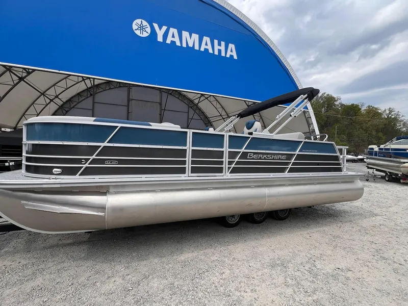Slide: The Image of 2025 Berkshire LE Series 24UL LE pontoon boat displayed at Yamaha dealership. - 8