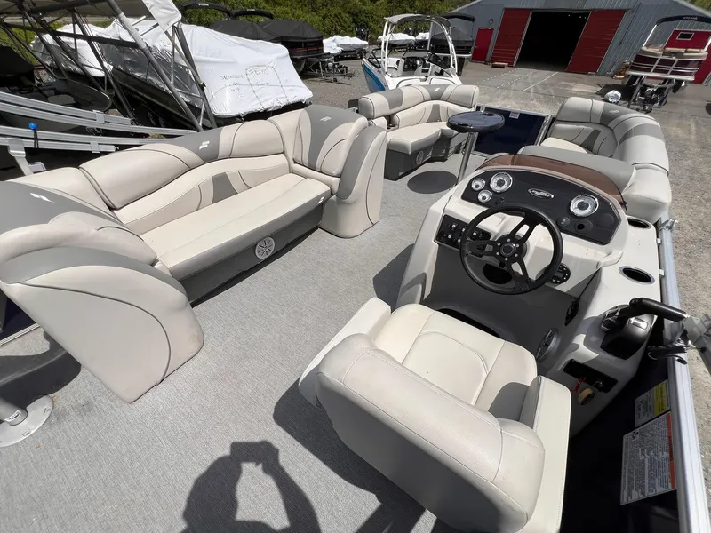 Slide: The Image of 2021 Starcraft EX Fish EX 22 FD pontoon boat interior with plush seating and steering console. - 11