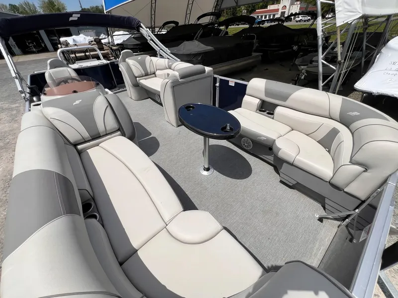 Slide: The Image of 2021 Starcraft EX Fish EX 22 FD pontoon boat interior with plush seating and table. - 13