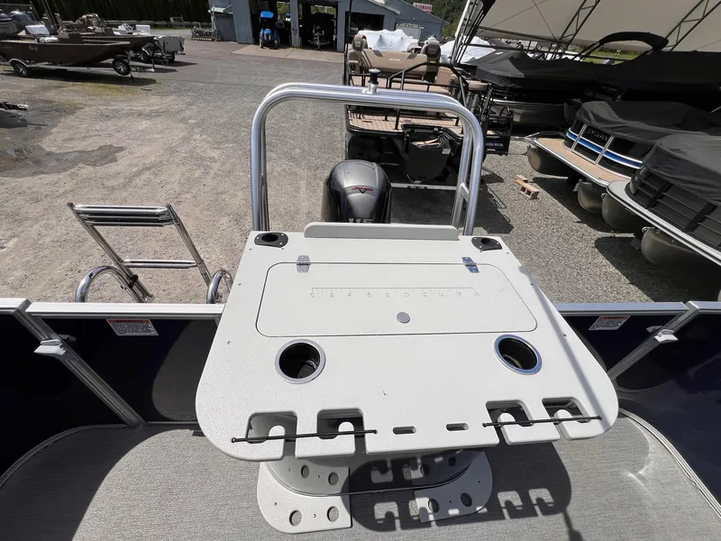 Slide: The Image of 2021 Starcraft EX Fish EX 22 FD boat with fishing station and motor, parked outdoors. - 14