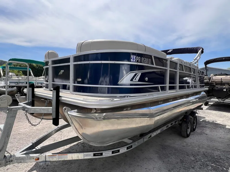 Slide: The Image of 2021 Starcraft EX Fish EX 22 FD pontoon boat on trailer, parked outdoors. - 17