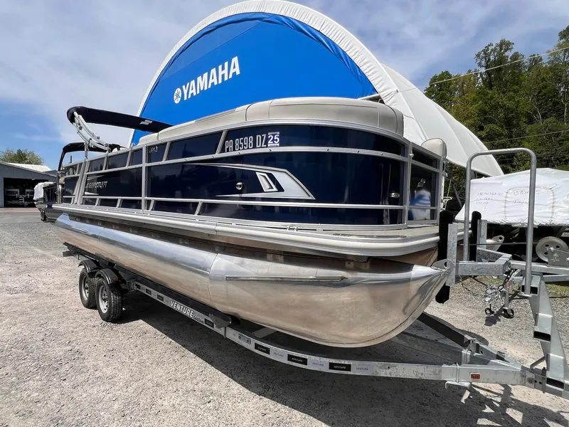 Slide: The Image of 2021 Starcraft EX Fish EX 22 FD pontoon boat on trailer, parked outdoors. - 19