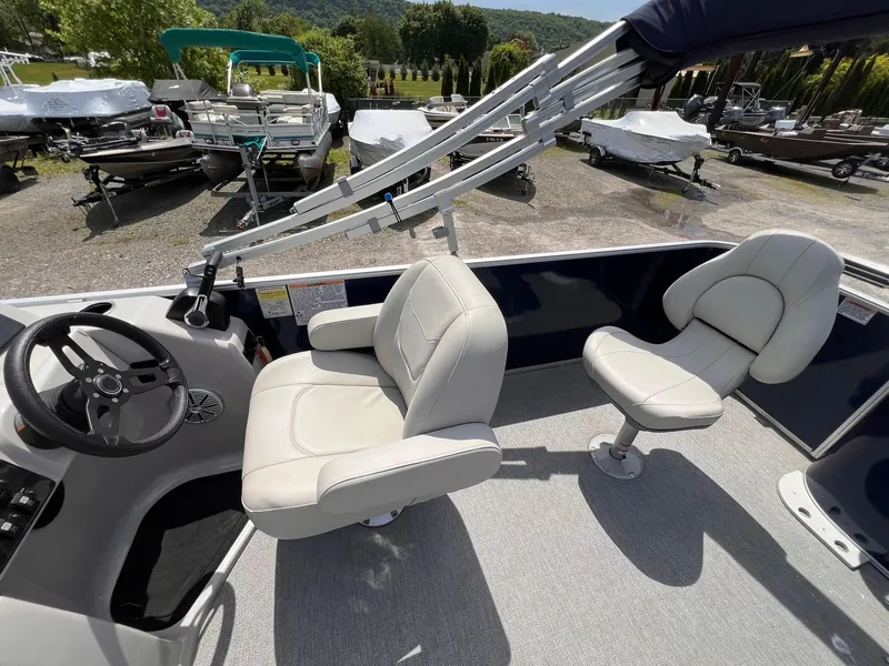 Slide: The Image of 2021 Starcraft EX Fish EX 22 FD boat interior with steering wheel and seating. - 21