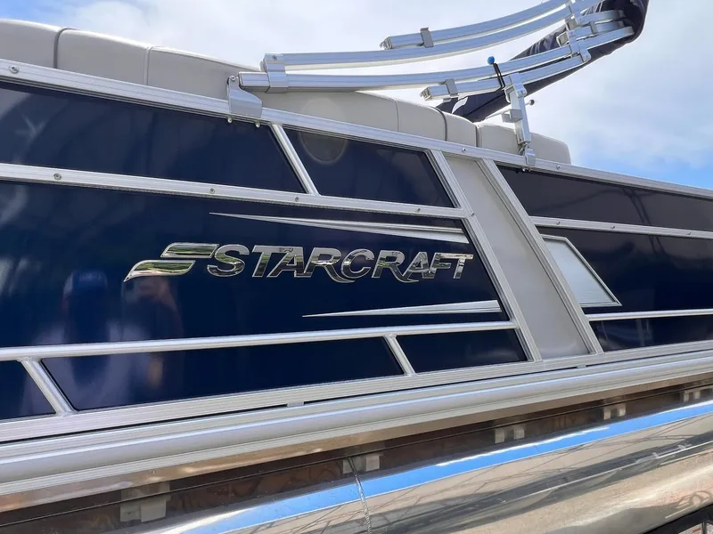 Slide: The Image of 2021 Starcraft EX Fish EX 22 FD boat with sleek blue and silver design. - 23