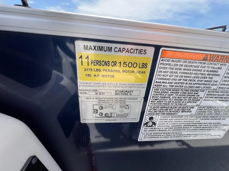 Slide: The Image of Capacity label on 2021 Starcraft EX Fish EX 22 FD boat, showing limits and safety warnings. - 25