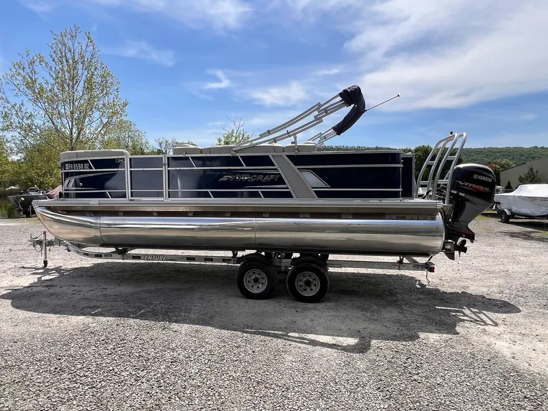 Slide: The Image of 2021 Starcraft EX Fish EX 22 FD pontoon boat on trailer, outdoors. - 4