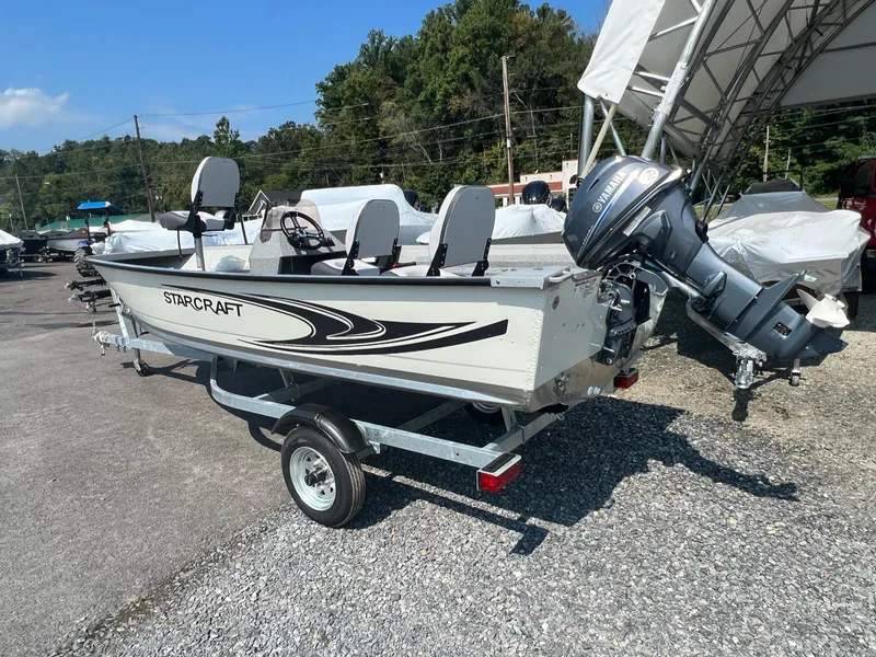 Slide: The Image of 2024 Starcraft Patriot 16 SC boat on trailer, parked outdoors. - 13