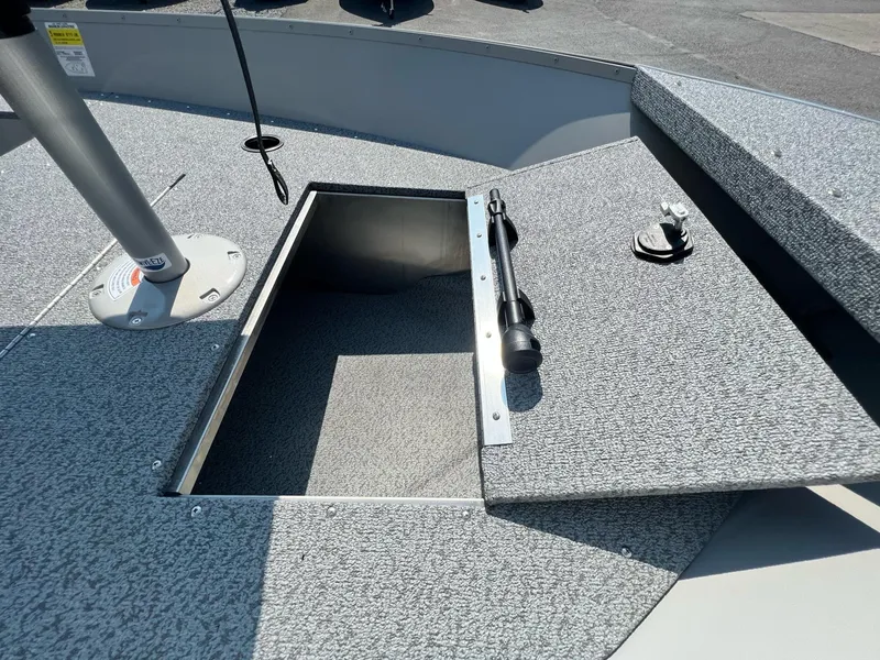 Slide: The Image of 2024 Starcraft Patriot 16 SC boat deck with open storage compartment. - 3