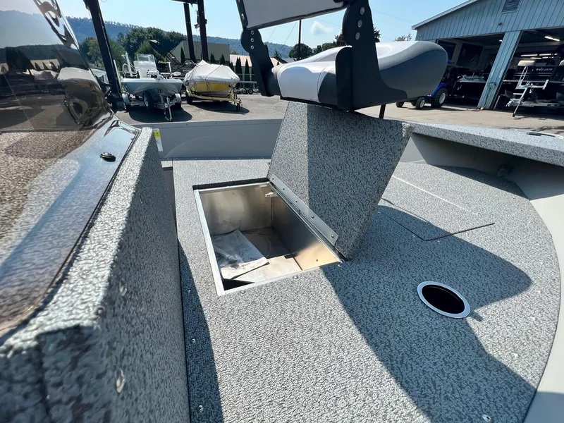 Slide: The Image of 2024 Starcraft Patriot 16 SC boat interior with storage compartment and seating. - 4