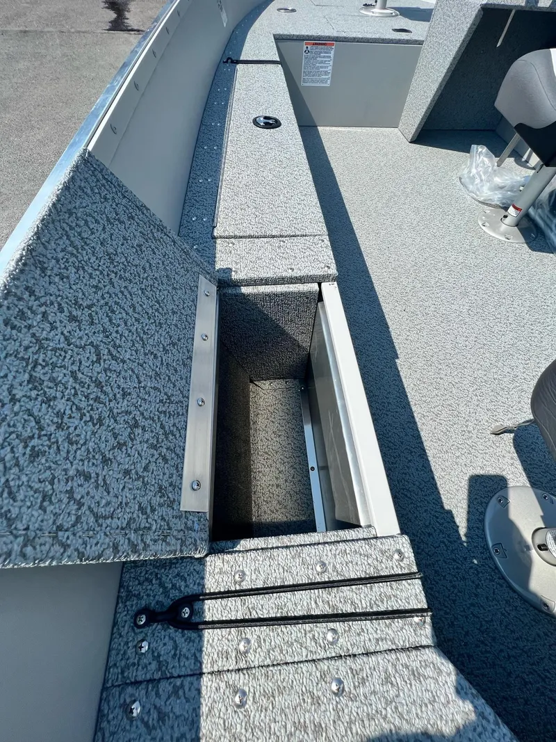 Slide: The Image of 2024 Starcraft Patriot 16 SC boat interior with open storage compartment. - 5