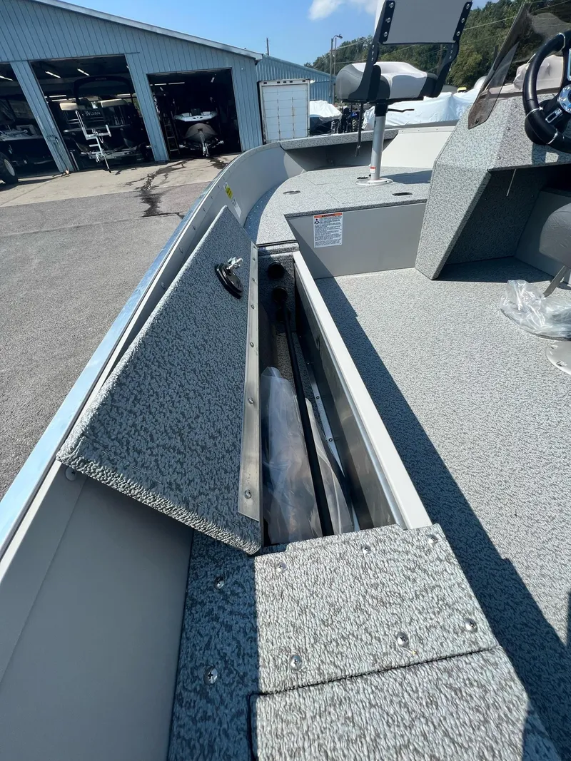 Slide: The Image of 2024 Starcraft Patriot 16 SC boat interior with open storage compartment. - 7