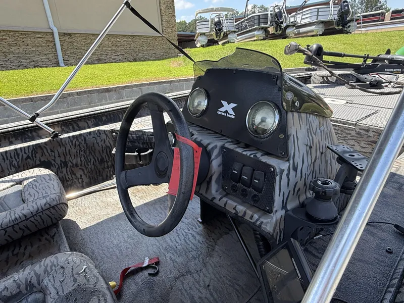 Slide: The Image of 2018 Xpress Xplorer Series XP180 boat interior with steering wheel and control panel. - 6