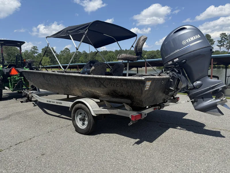 Slide: The Image of 2018 Xpress Xplorer Series XP180 boat with Yamaha motor on trailer, parked outdoors. - 7