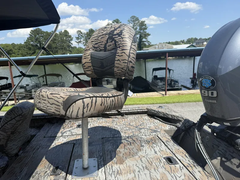 Slide: The Image of 2018 Xpress Xplorer Series XP180 boat with camo seat and Yamaha 90 engine by a lake. - 9