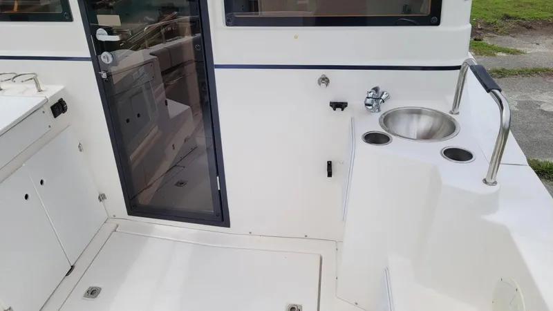 Slide: The Image of 2021 Cutwater C-28 boat deck with sink and door, showcasing sleek design and functionality. - 10