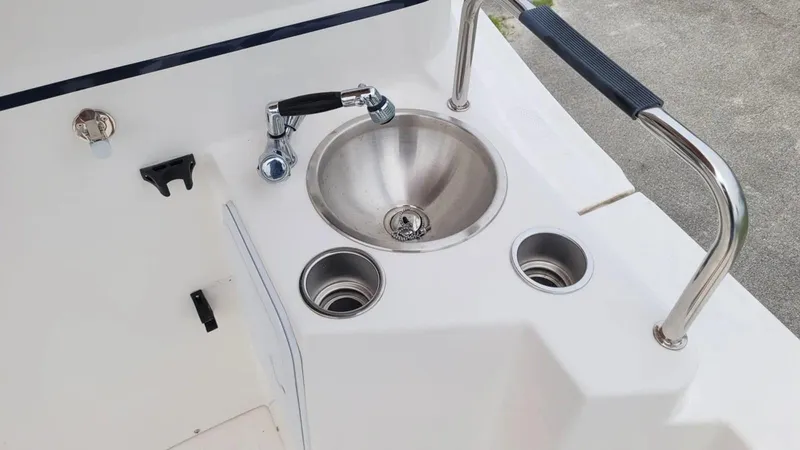 Slide: The Image of 2021 Cutwater C-28 boat sink with faucet and cup holders on deck. - 13