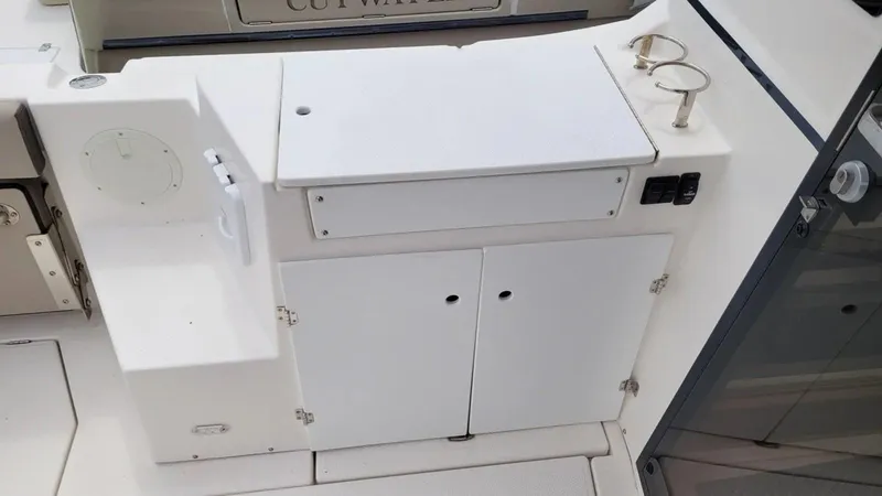 Slide: The Image of 2021 Cutwater C-28 boat interior with storage compartments and cup holders. - 14