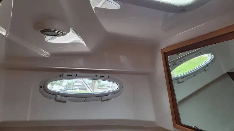 Slide: The Image of Interior of 2021 Cutwater C-28 boat with oval window and mirror. - 30