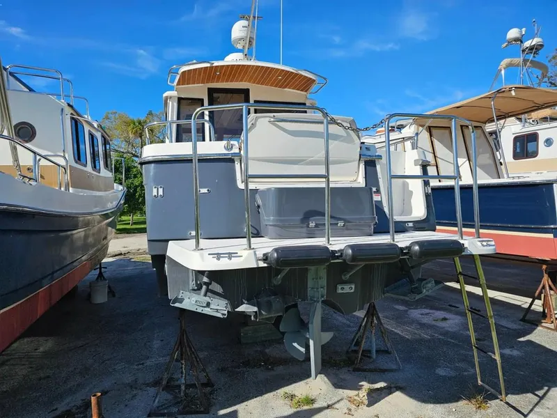 Slide: The Image of 2021 Cutwater C-28 boat on dry dock, surrounded by other vessels under a clear blue sky. - 5