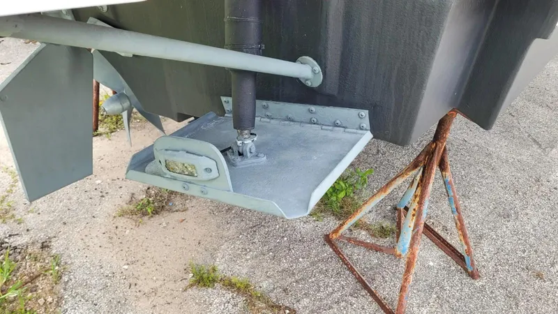 Slide: The Image of 2021 Cutwater C-28 boat hull with propeller and rudder on a stand. - 7