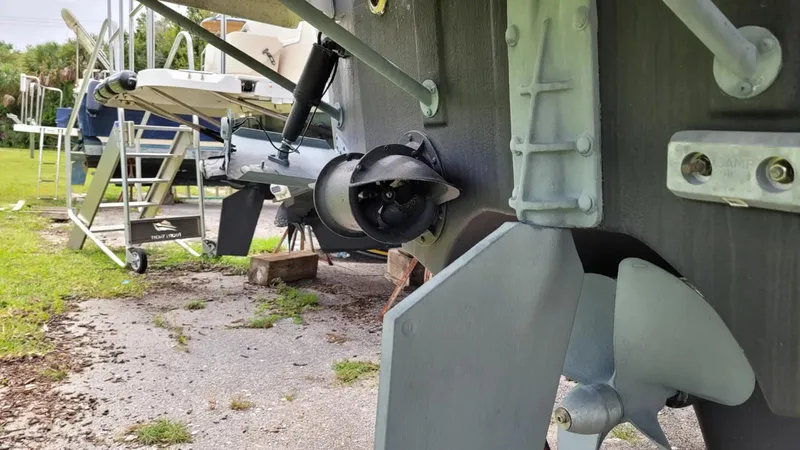 Slide: The Image of 2021 Cutwater C-28 boat propeller and rudder detail in a yard setting. - 9