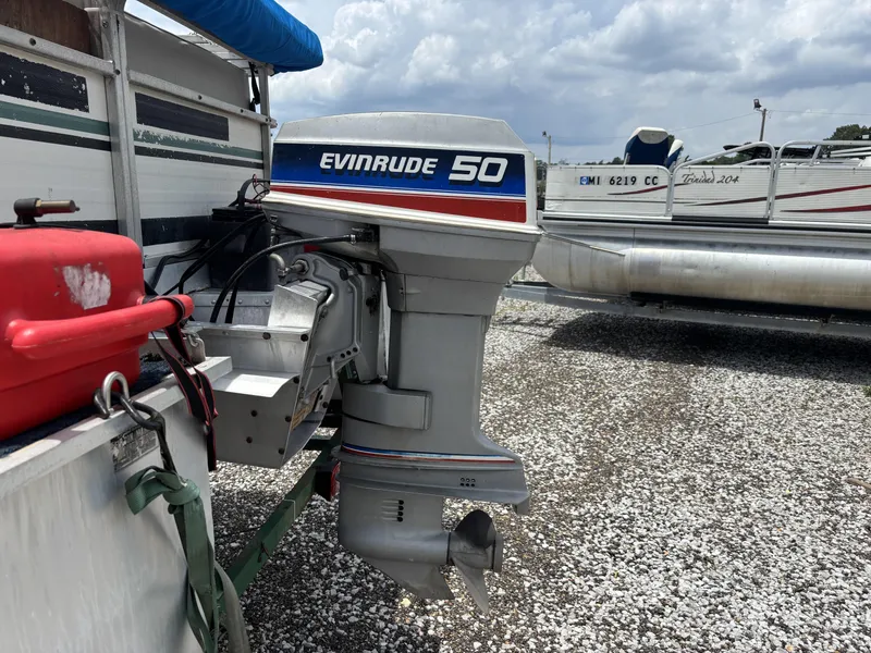 Slide: The Image of 1987 Lowe FISH AND FUN 18 with Evinrude 50 outboard motor on gravel lot. - 3