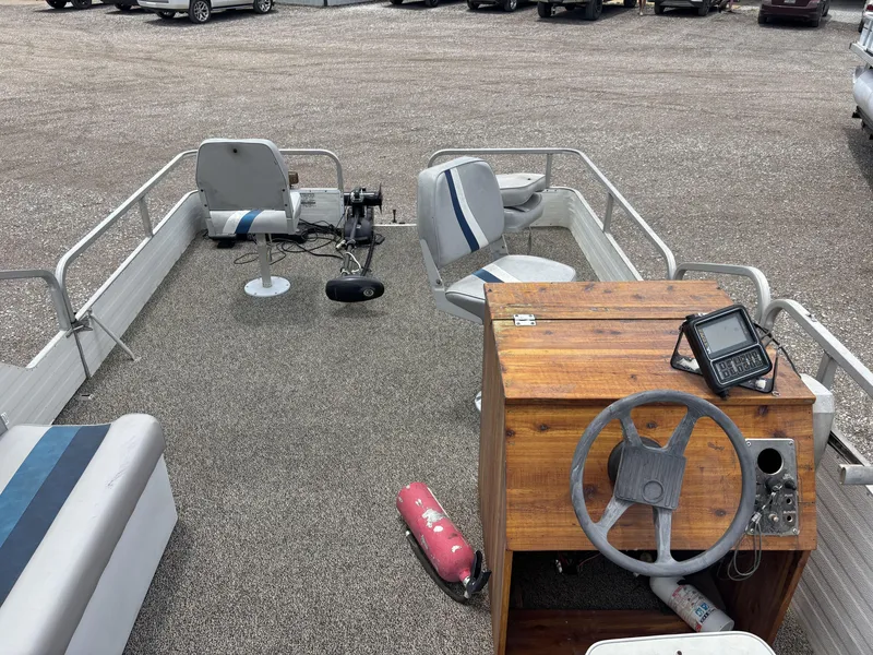 Slide: The Image of 1987 Lowe FISH AND FUN 18 boat interior with steering wheel and seating. - 5