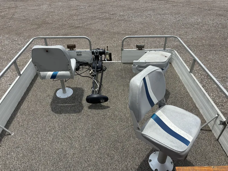 Slide: The Image of 1987 Lowe FISH AND FUN 18 boat interior with two swivel seats and a trolling motor. - 6