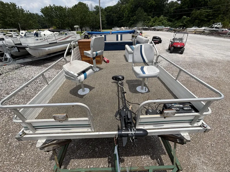 Slide: The Image of 1987 Lowe FISH AND FUN 18 pontoon boat with seating, parked on gravel lot. - 9